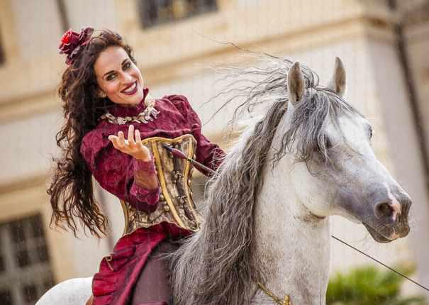 artiste en costume sur cheval gris